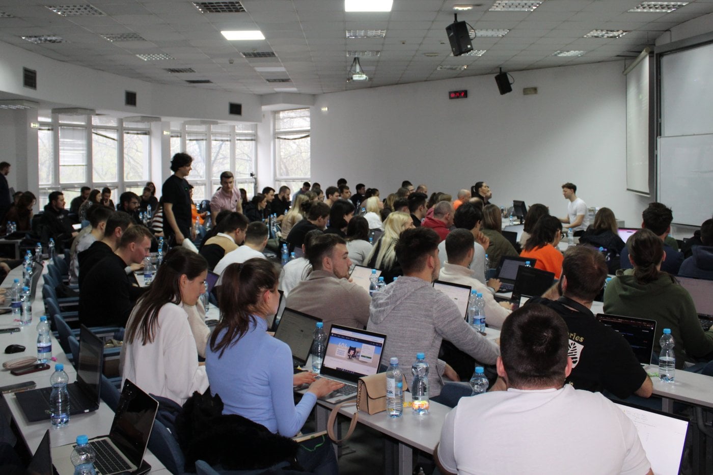 Students on laptops at a UkisAI Academy bootcamp